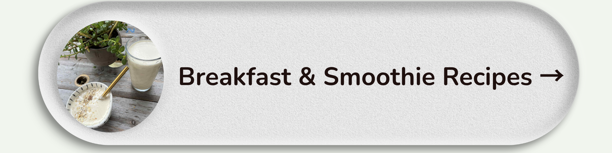 Circular photo showing a bowl of oatmeal with a spoon, a glass of milk, and a potted plant on a wooden surface, with a label reading 'Breakfast & Smoothie Recipes' and an arrow.