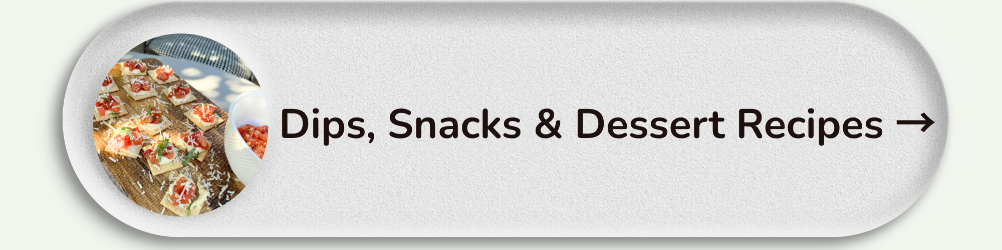 A circular image showing appetizers or snacks on a wire rack next to a bowl of chopped tomatoes. To the right, text reads "Dips, Snacks & Dessert Recipes" with an arrow indicating navigation.