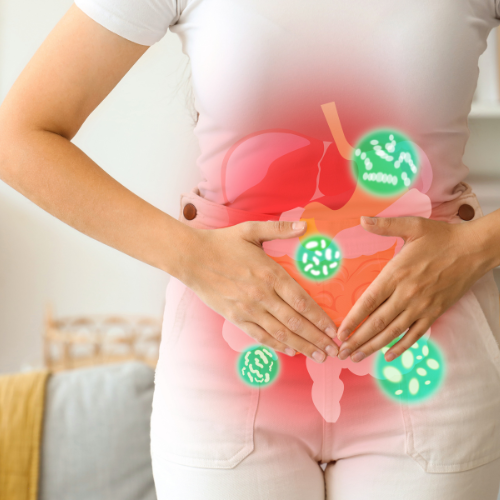 A person with hands on stomach, showing a digital overlay of a stomach and digestive bacteria.