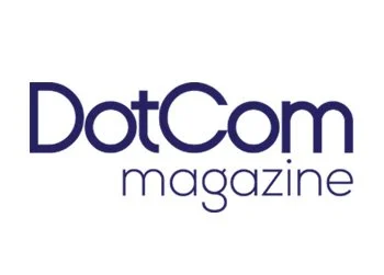 DotCom Magazine logo with purple text on a white background.