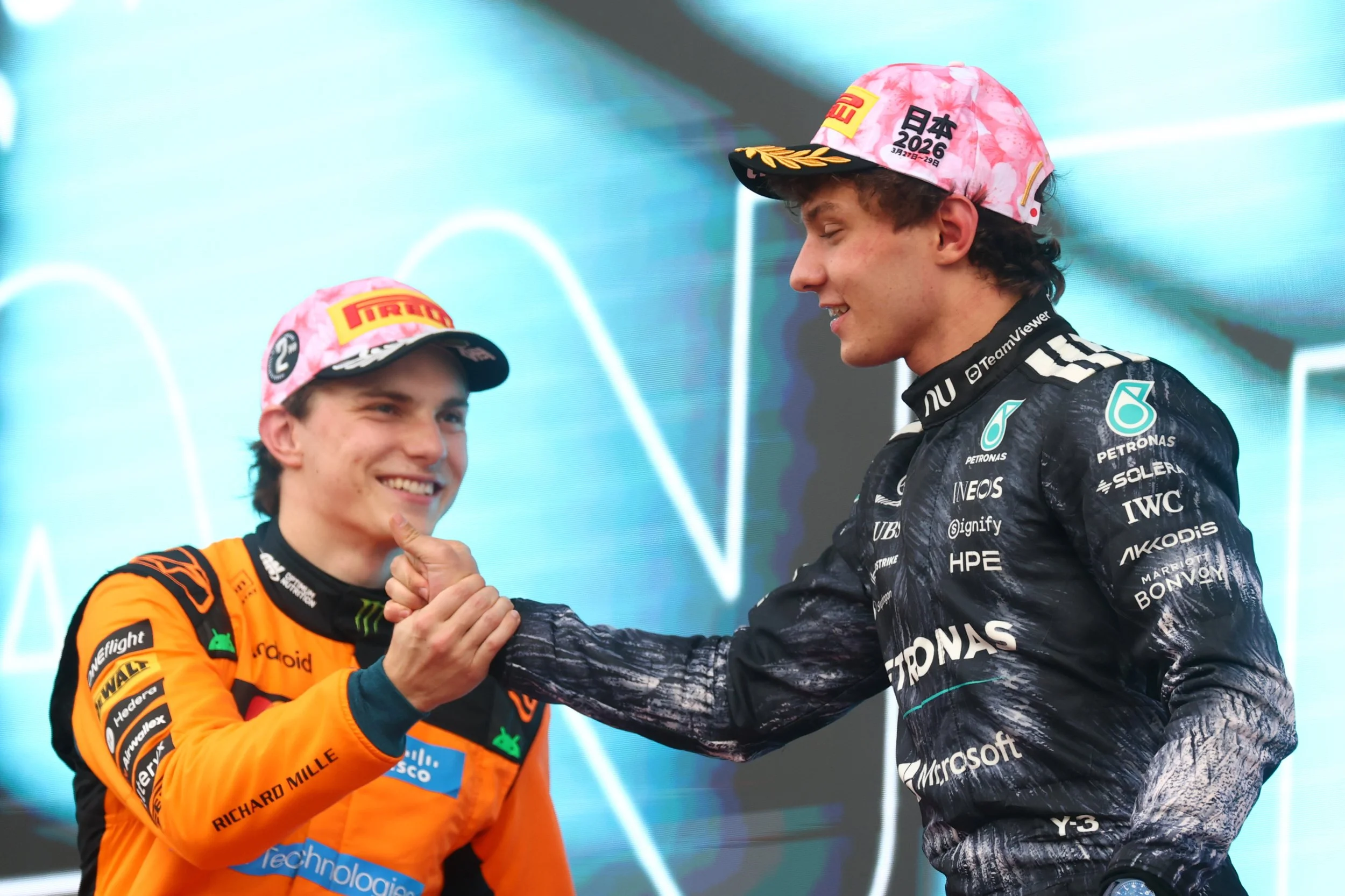 Oscar Piastri and Kimi Antonelli greet each other on the podium at the 2026 Japanese Grand Prix.