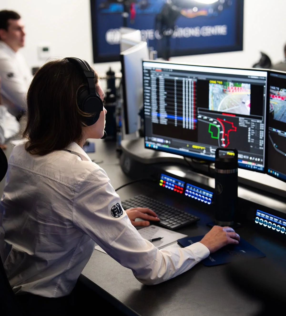 An FIA analyst wearing a headset reviews track footage and car positioning data in the Remote Operations Centre