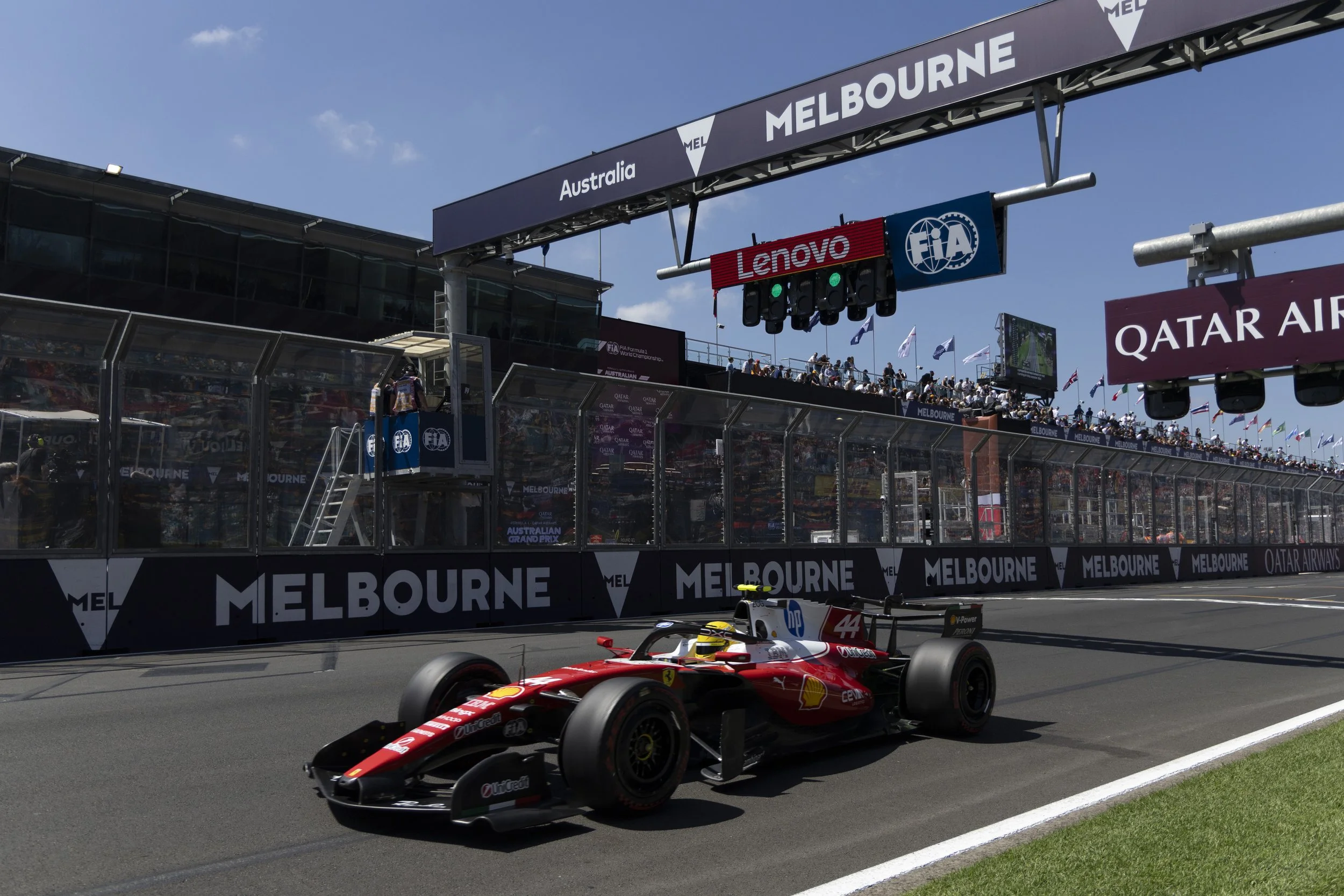 Lewis Hamilton on the starting grid at the Melbourne Grand Prix 2026 in Australia, with the race officials and spectators in the background.