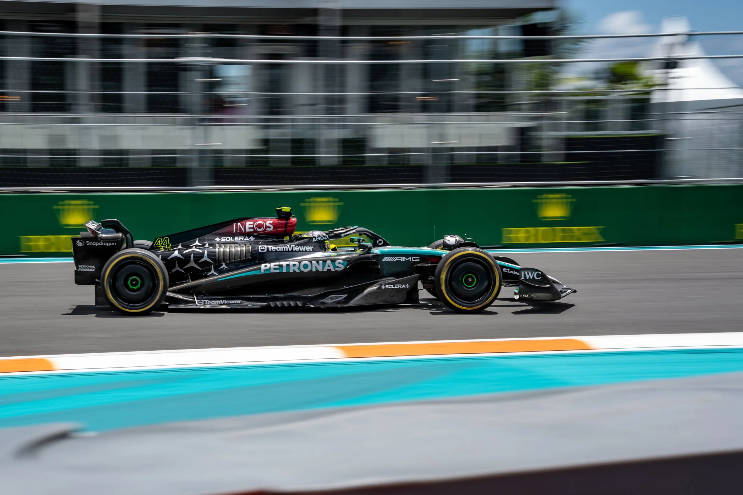 A Formula 1 race car speeding on a race track with blurred background, displaying sponsors like Petronas and AMG.
