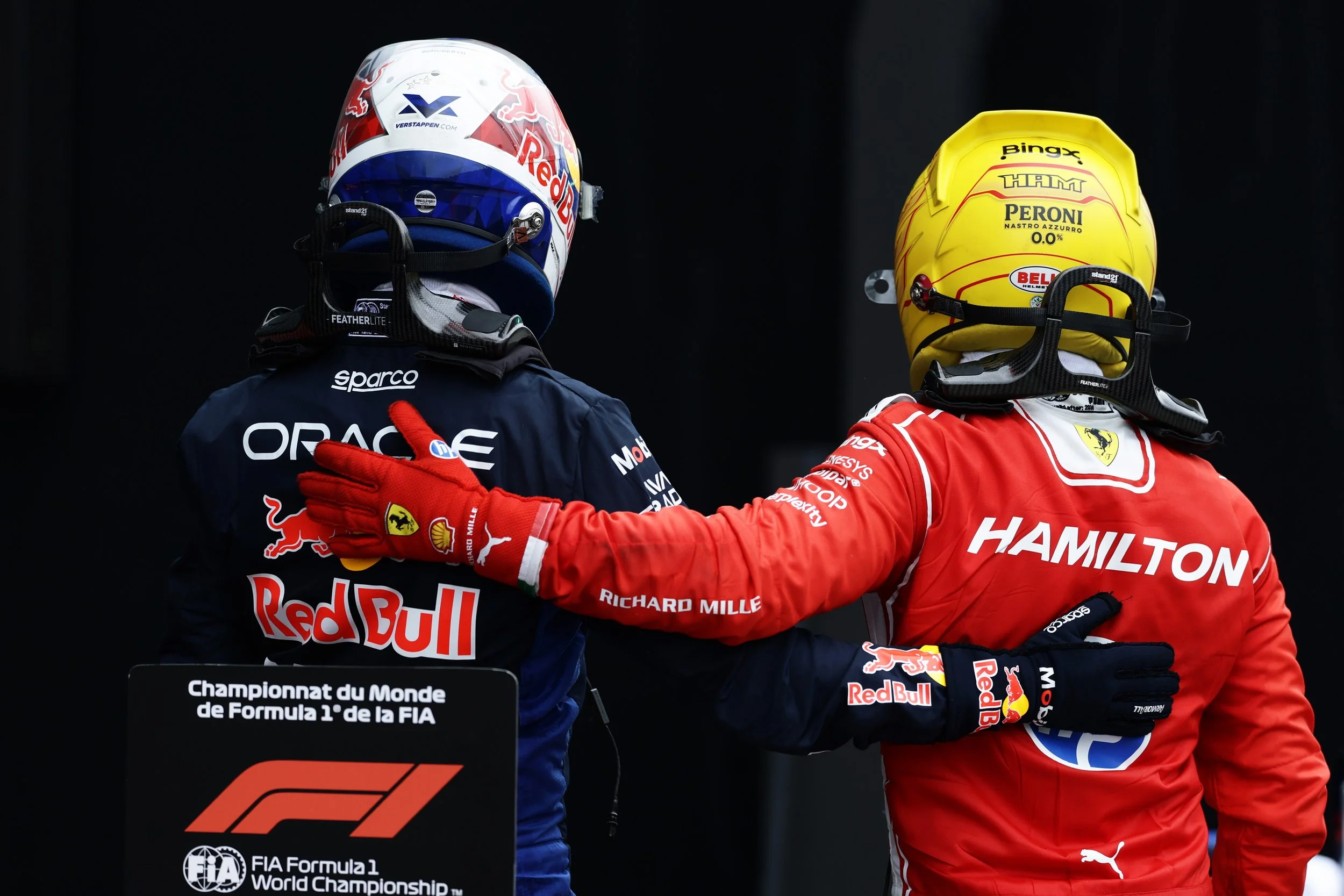 Lewis Hamilton embraces Max Verstappen after a Formula 1 race.