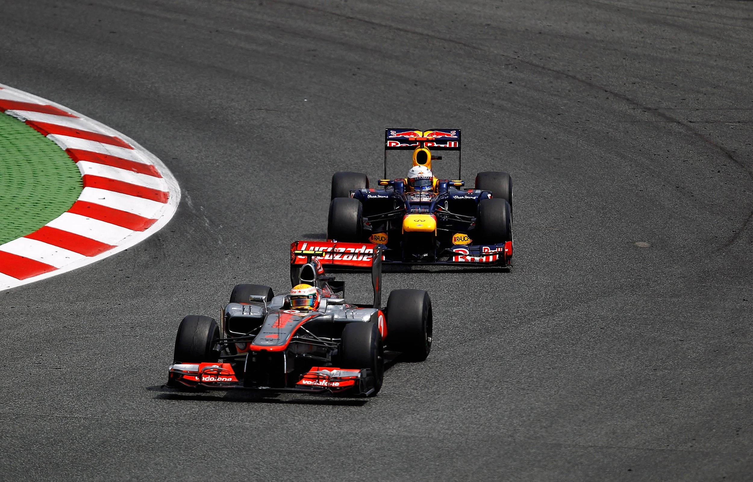 McLaren and Red Bull Formula 1 cars on track at the 2012 Spanish Grand Prix