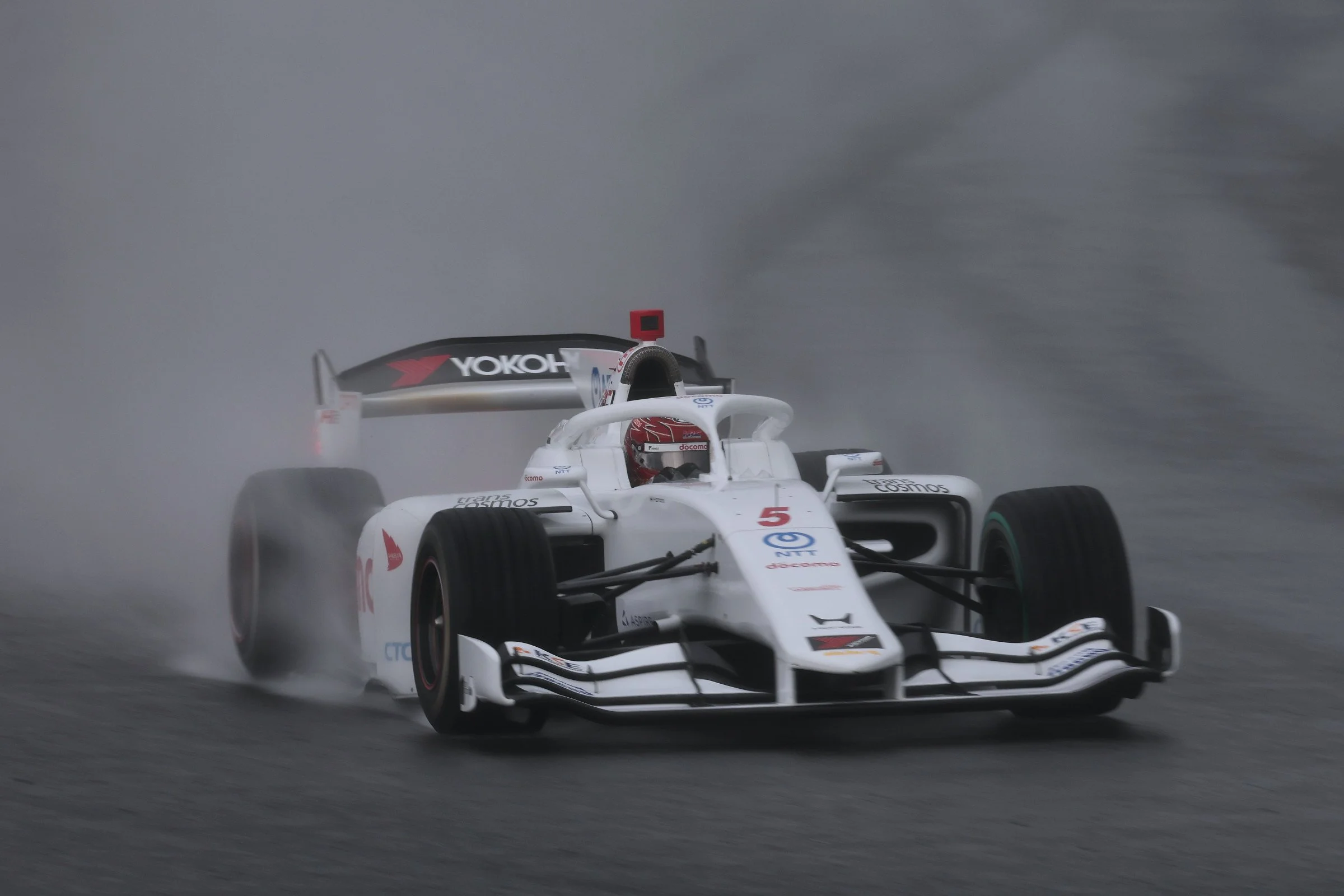 Kakunoshin Ohta drives the No. 5 Dandelion Racing car during a wet Super Formula race.