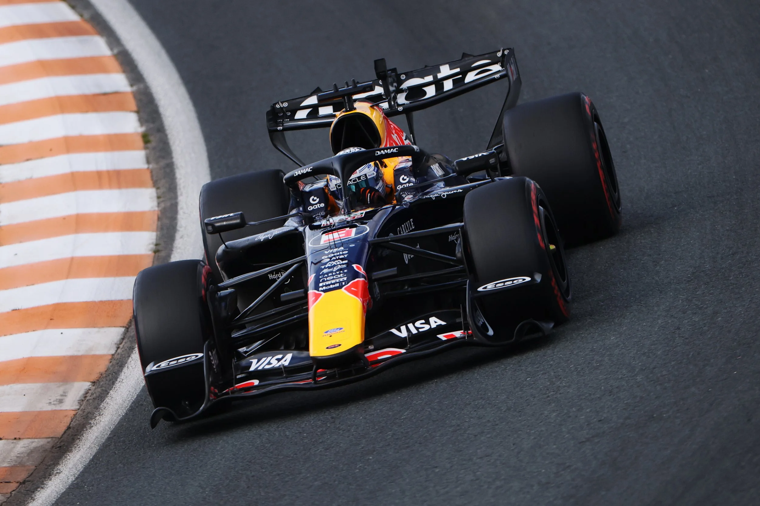 Max Verstappen drives his Red Bull Racing car over the kerbs at the 2026 Dutch Grand Prix.