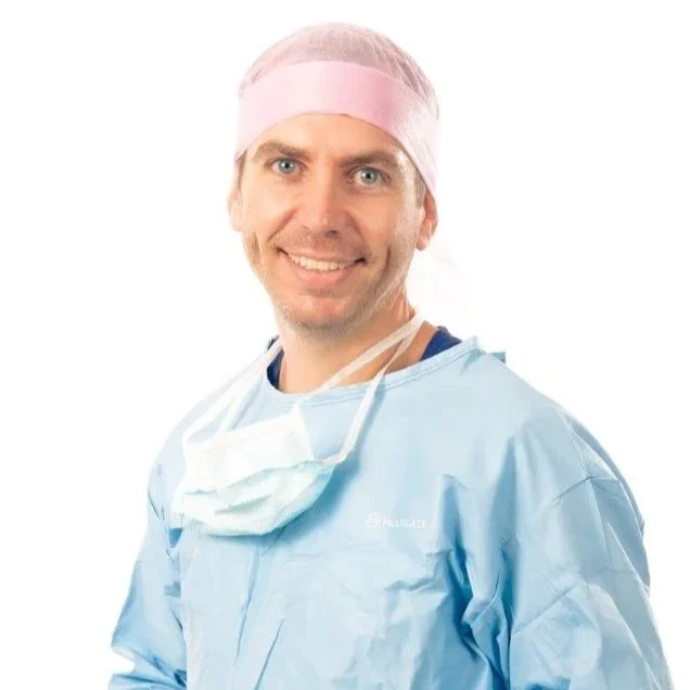Matthew Robinson, veterinary surgeon at Stifle Surgeons, in surgical gown and cap.