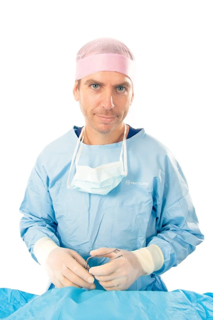 Matthew Robinson, veterinary surgeon, in surgical gown and gloves.