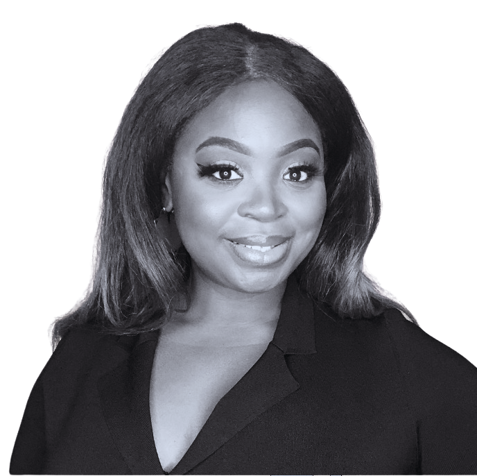 A woman with shoulder-length hair smiling, wearing a black top, against a dark background.