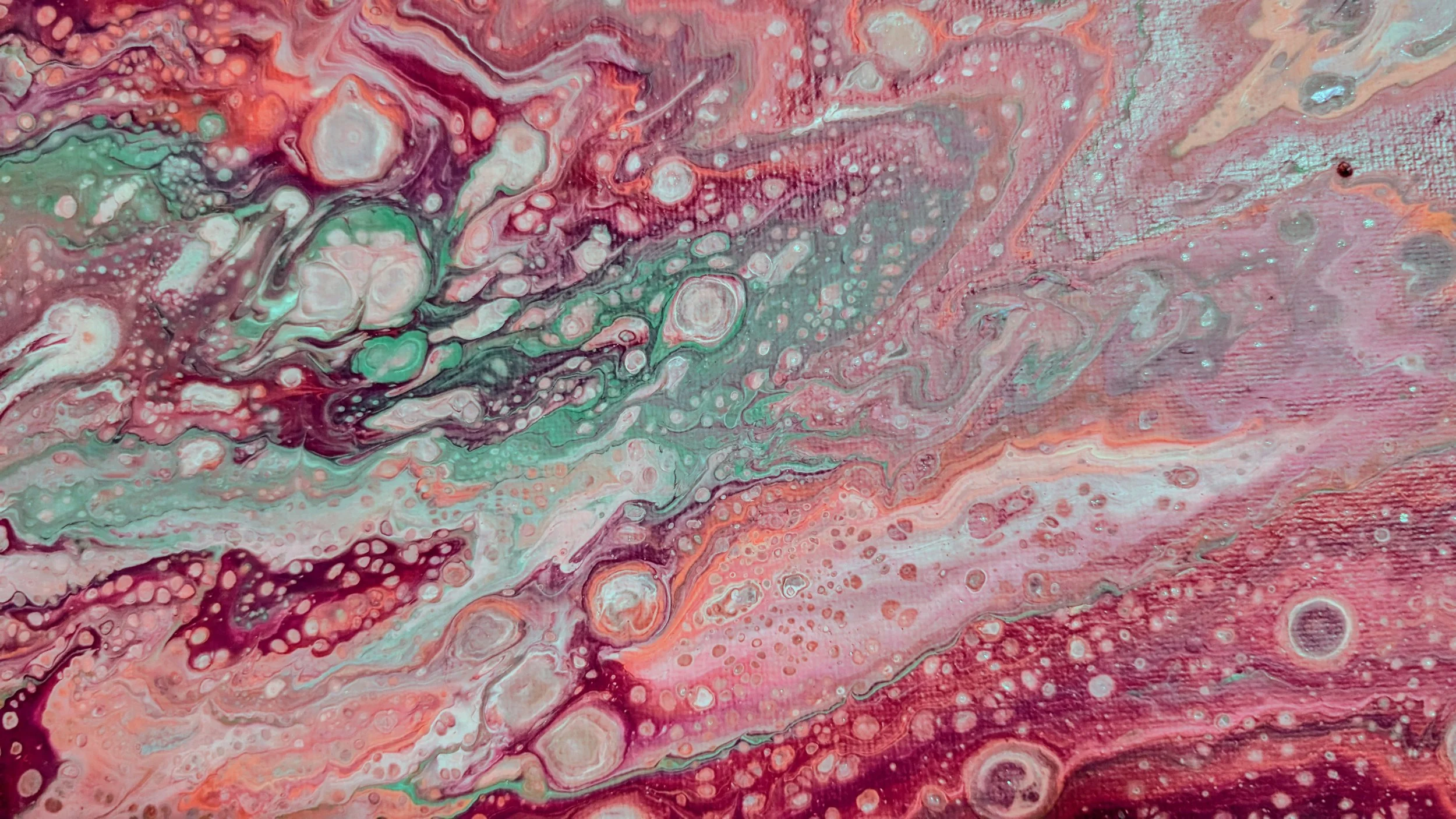 Abstract painting with pink, red, teal, and purple swirling colors and bubble-like textures.