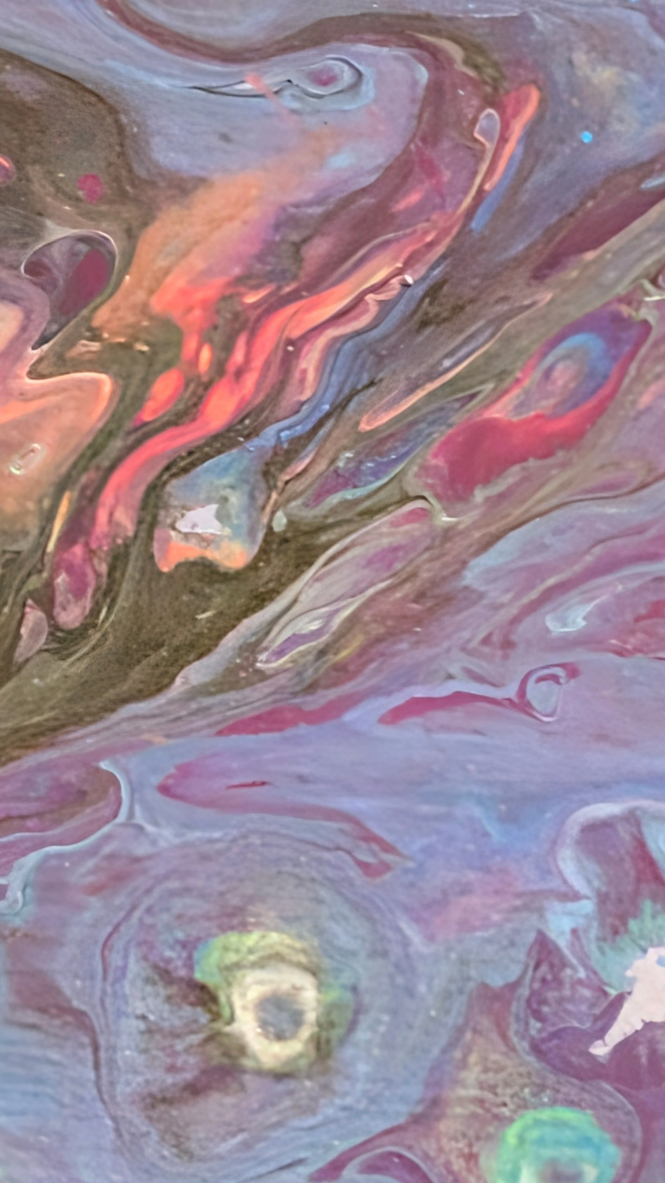 Abstract swirl of pink, purple, blue, and gold paint with flowing, marbled textures.