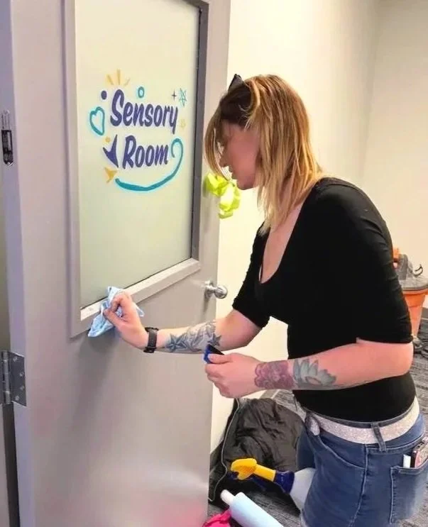 Installing printed window frost at Adaptabilities' St. Albert Location