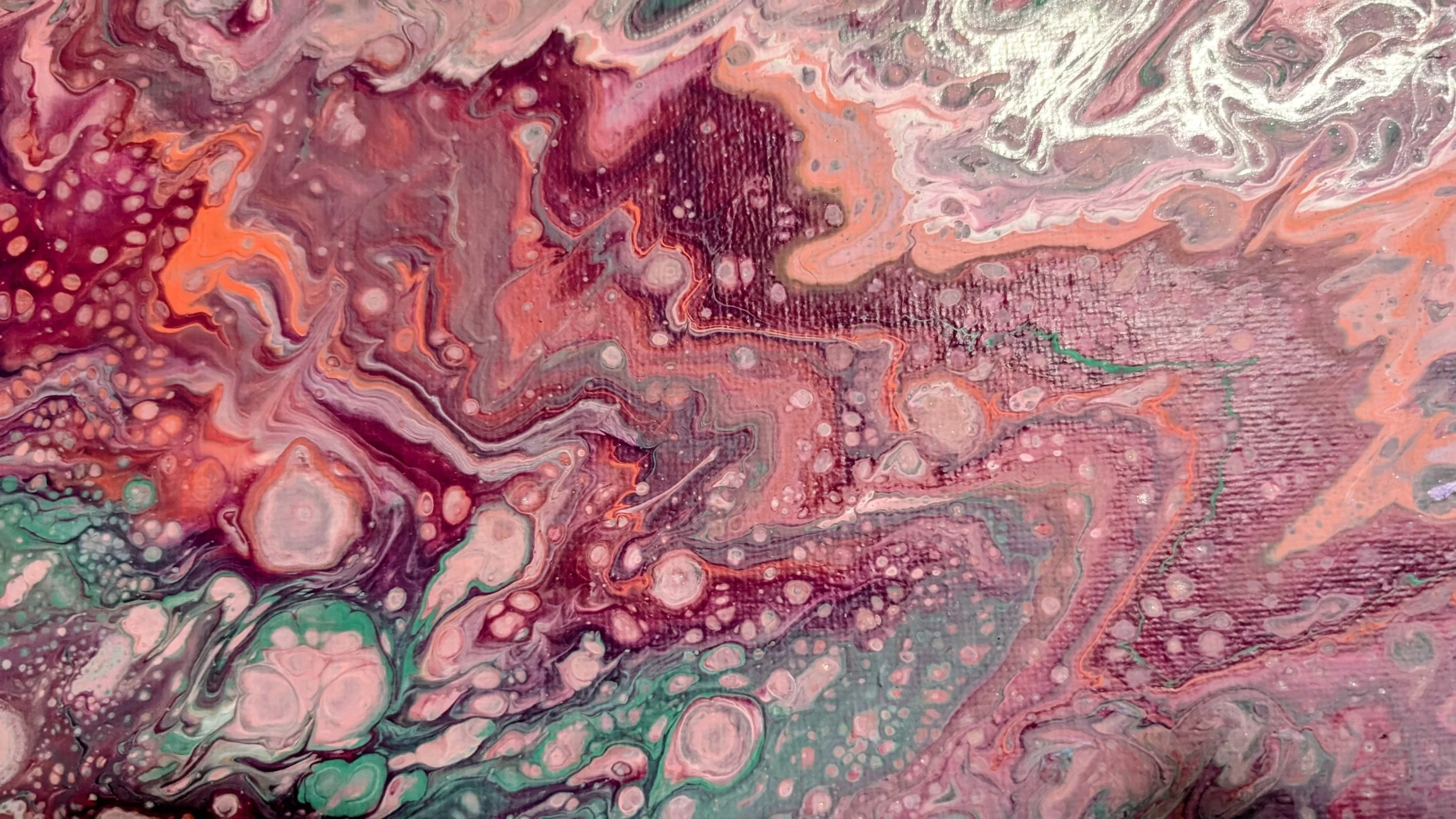 Abstract fluid art painting with swirling pink, red, purple, green, and white colors and bubble-like patterns.