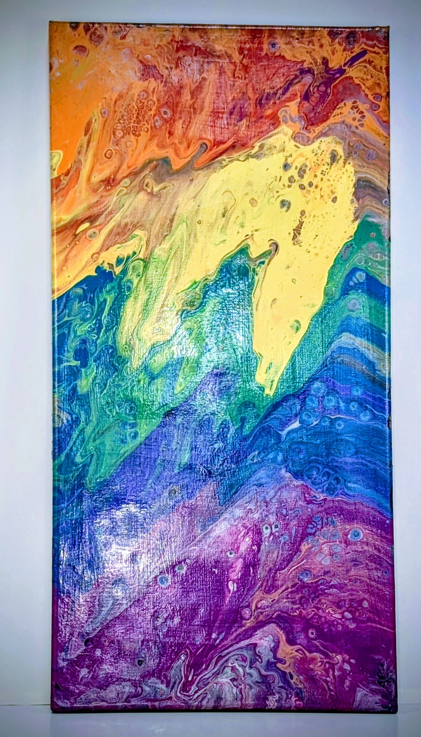 Abstract colorful painting with swirling patterns in shades of red, yellow, green, blue, and purple.