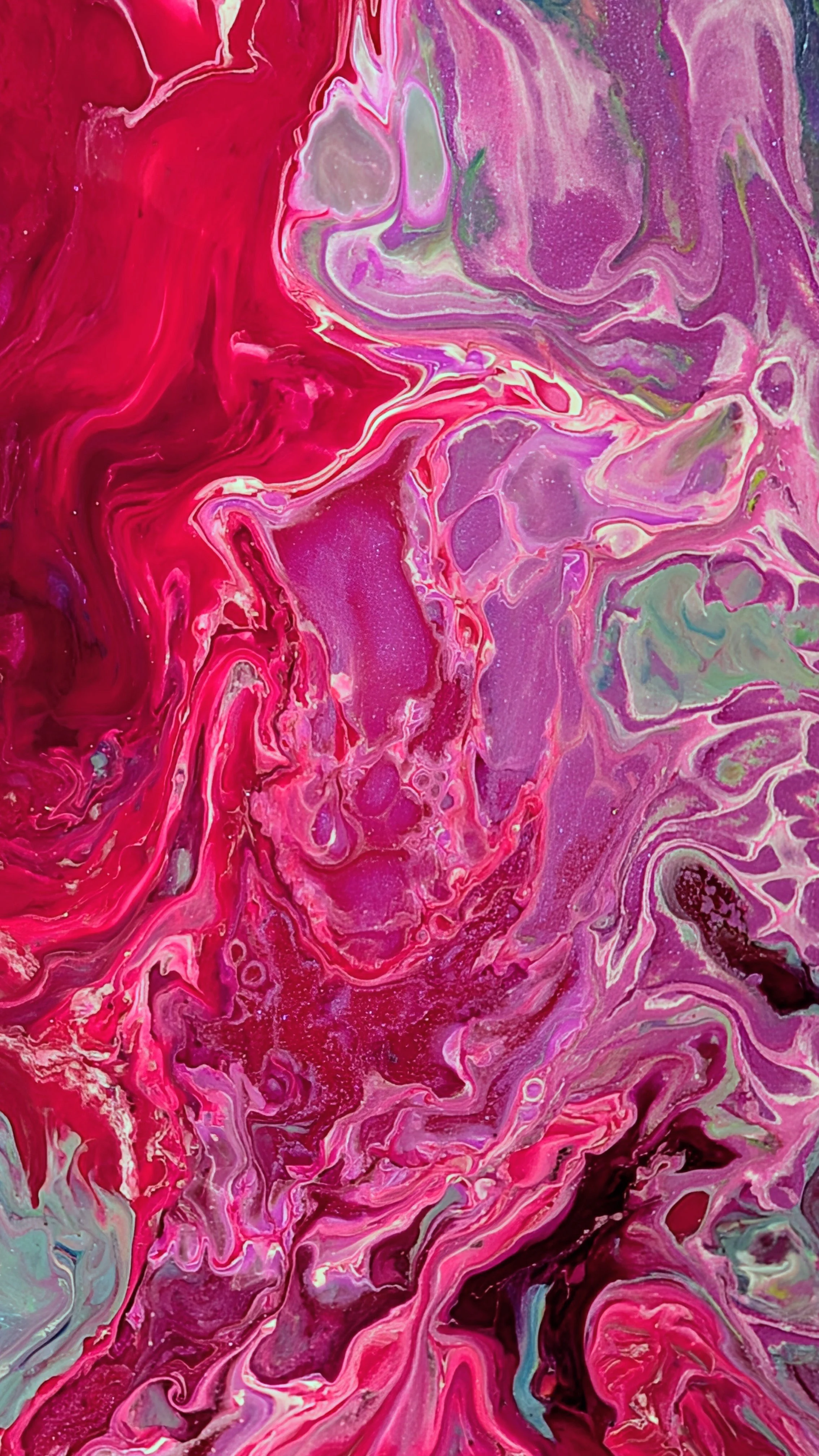 Abstract fluid art with pink, red, purple, green, and black swirls and patterns.