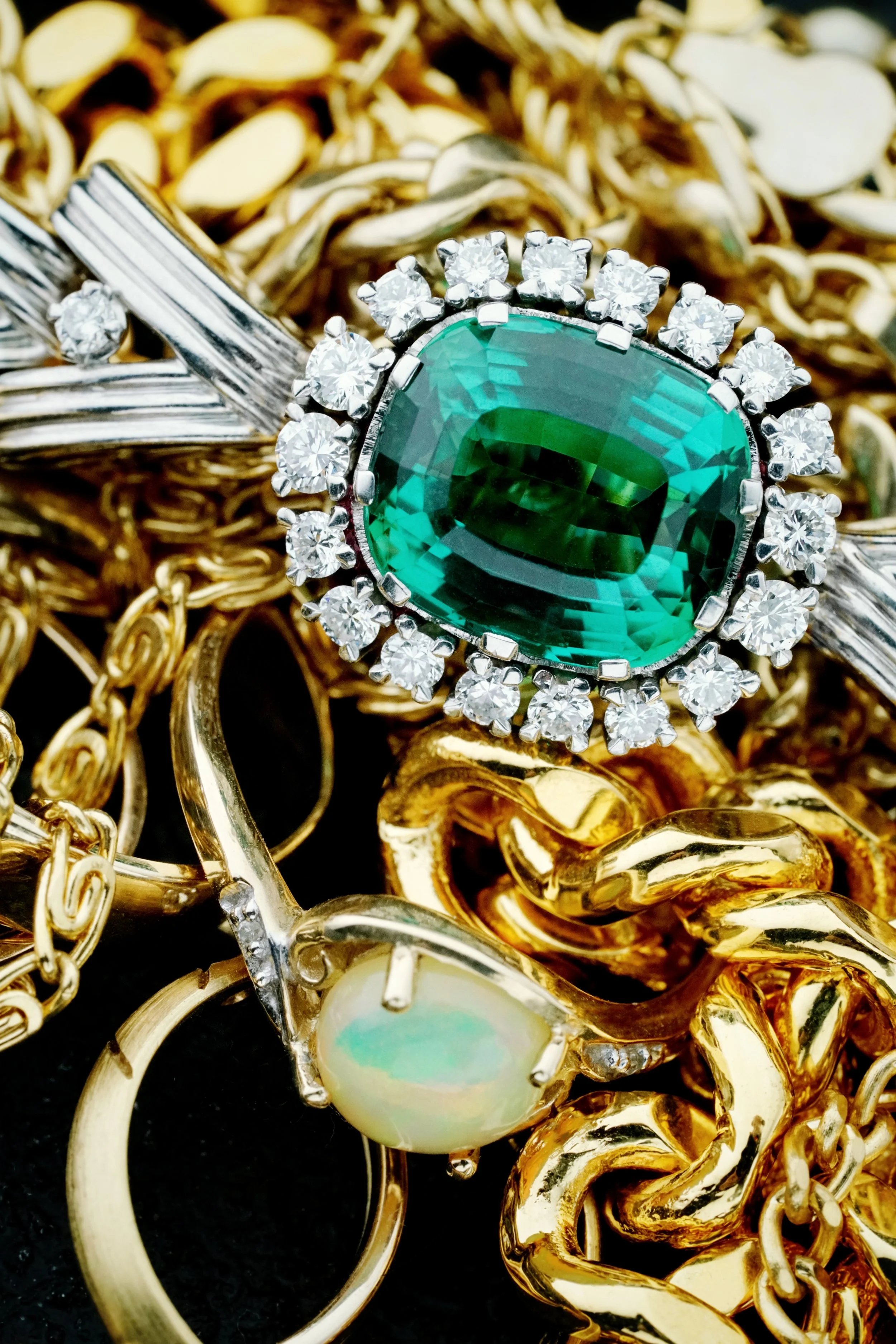 gold-jewelry-pile-and-large-gemstone-2024-12-06-15-55-43-utc.jpg