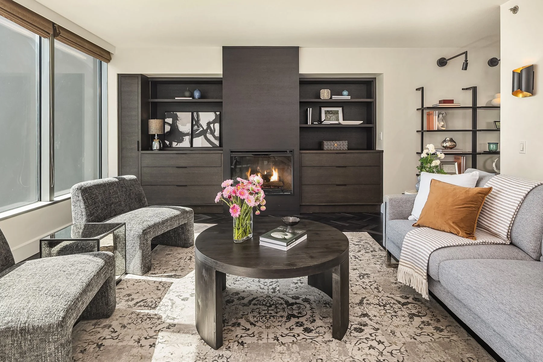 Staged living room with built-in shelving and fireplace wall in a downtown Seattle condo