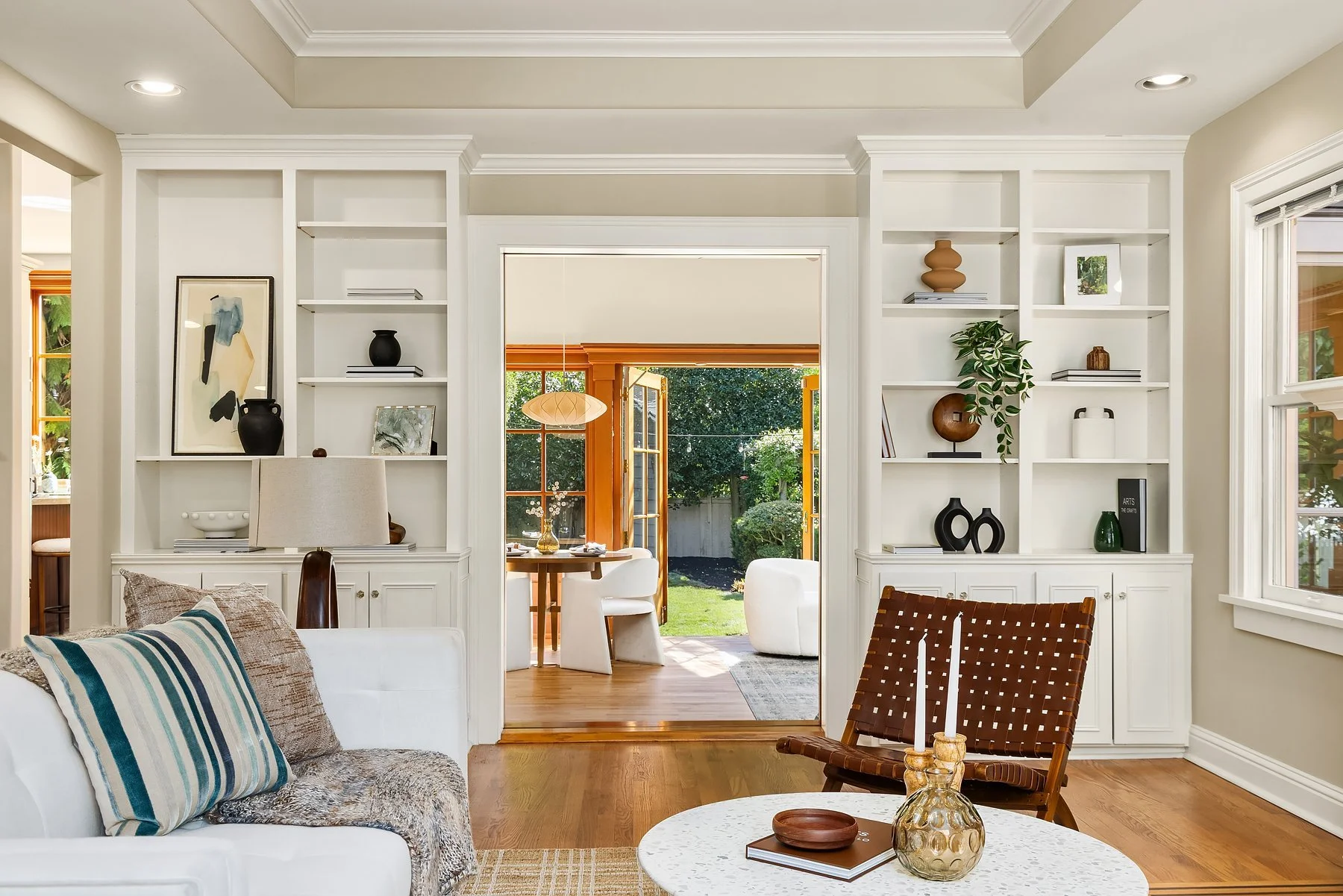 Living room built-ins framing French doors to the garden in a classic Madison Park home, Seattle
