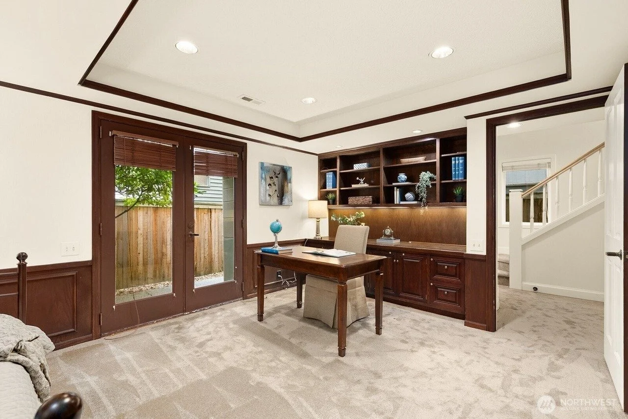 Staged home office with wood paneling and built-in shelves in a Madison Park townhouse, Seattle
