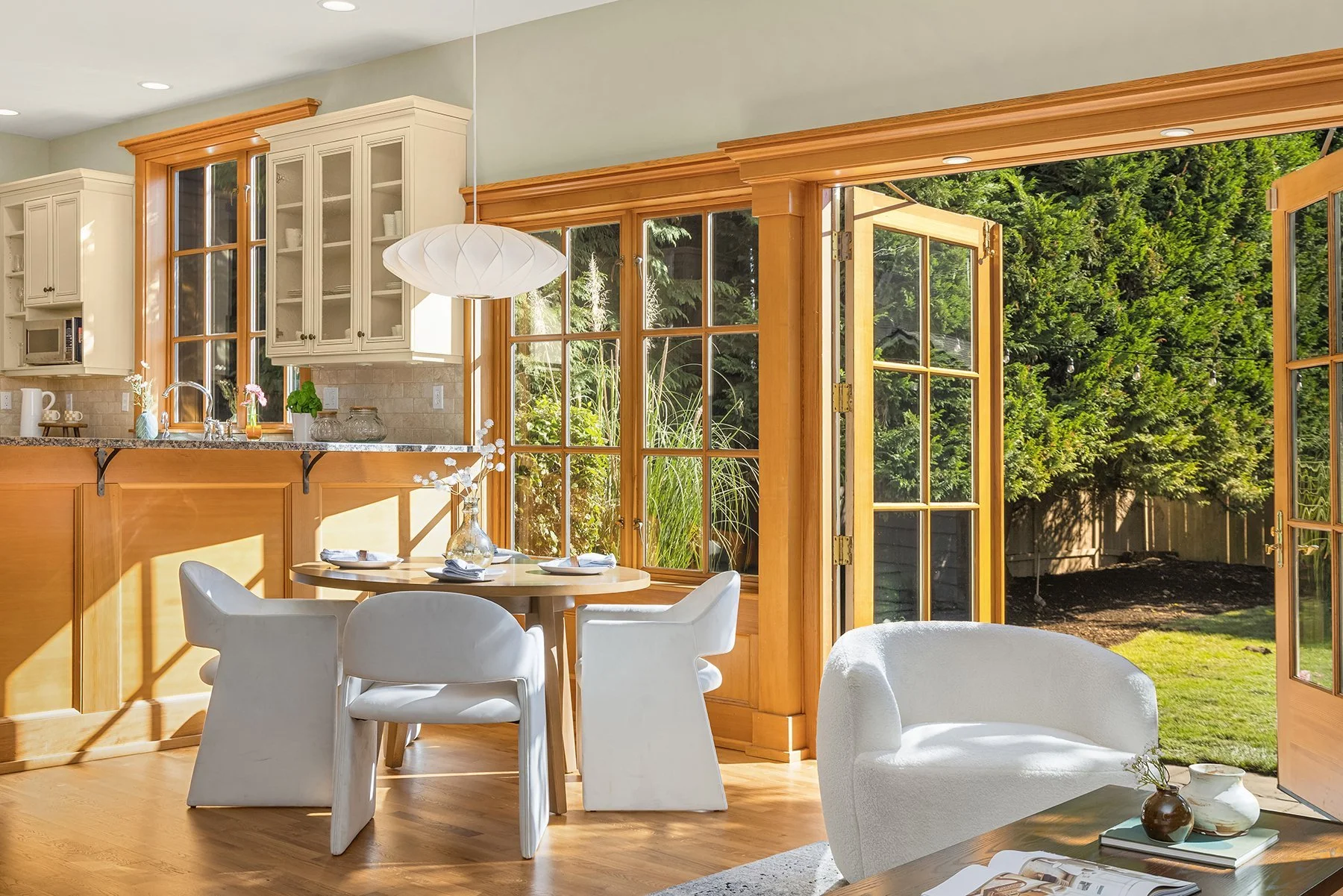 Breakfast area with round table beside French doors to the garden in a classic Madison Park home, Seattle