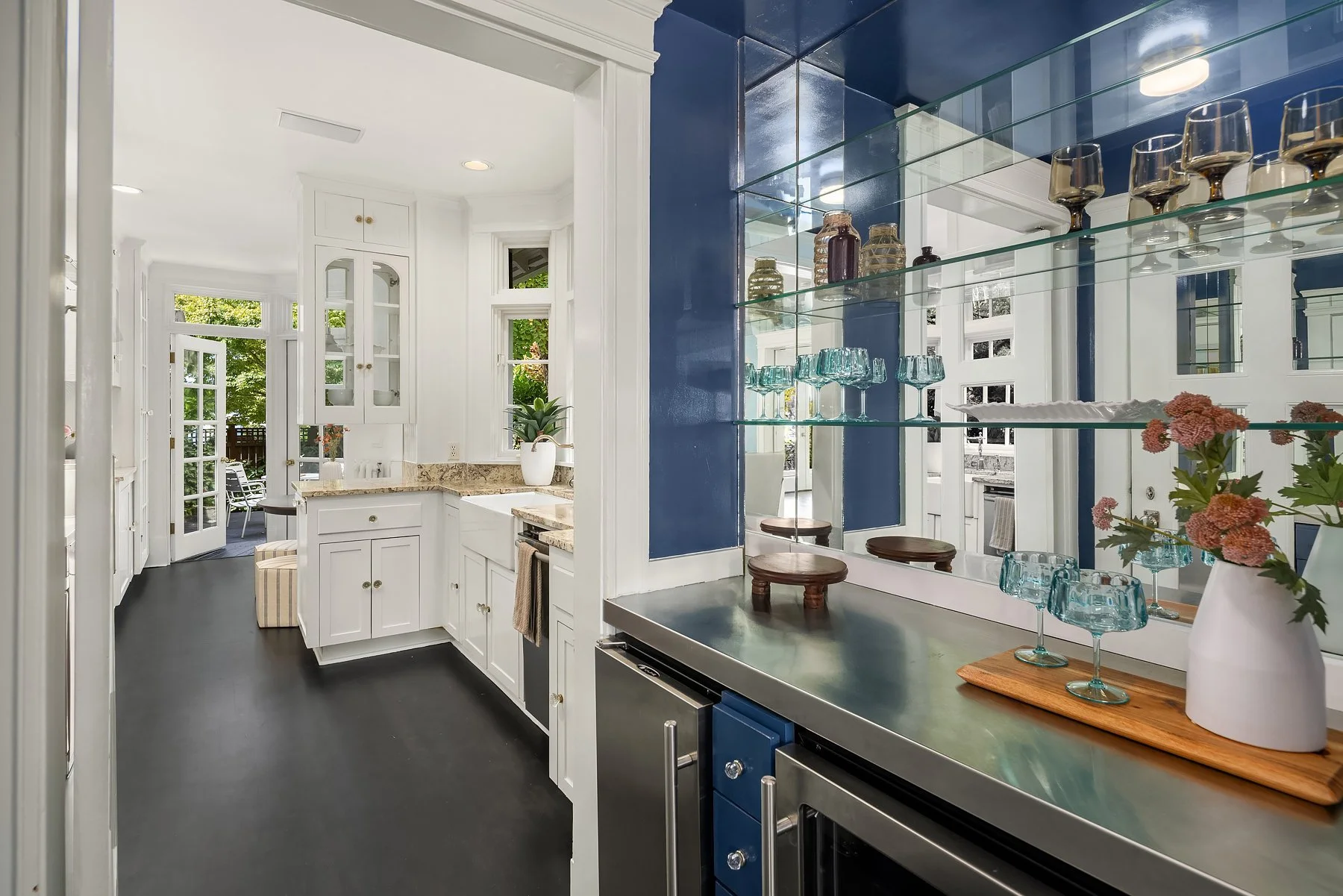 Kitchen with navy glass-front cabinets and a styled coffee bar in a Seattle home