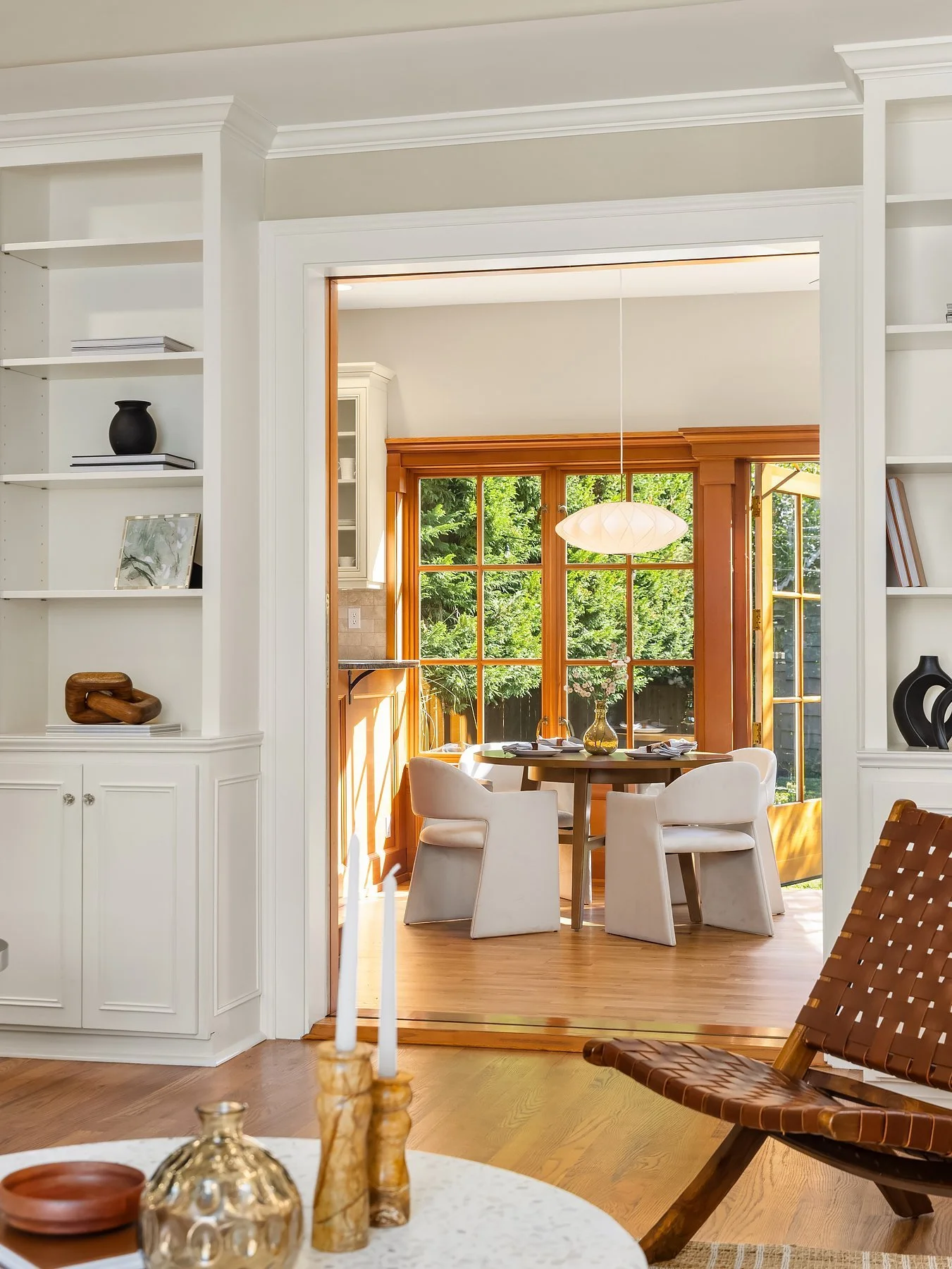 View from the living room into a garden-facing family room in a classic Madison Park home, Seattle