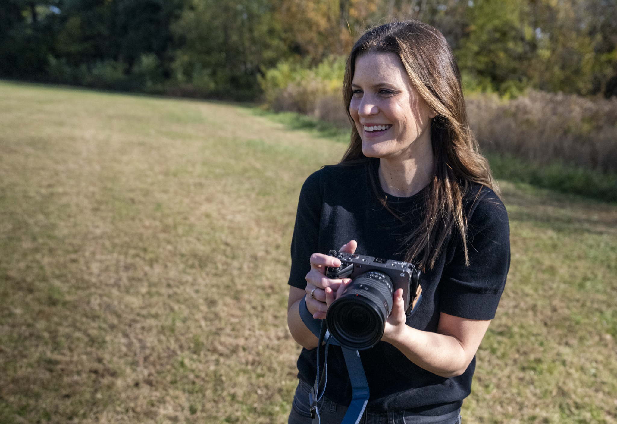 Tara O’Brien, documentary family videographer in Louisville, Kentucky, holding her camera during a lifestyle family film shoot.