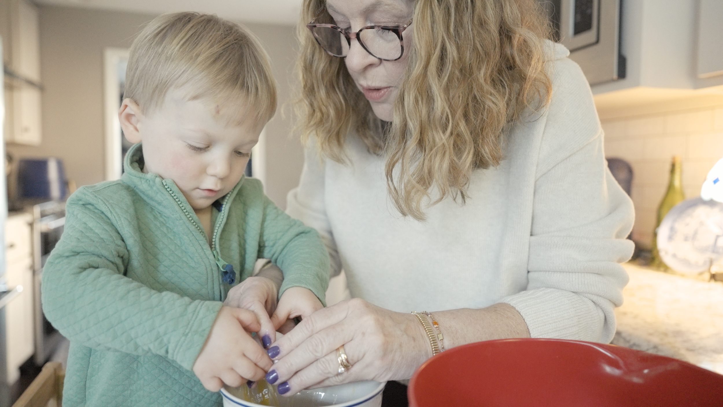 Grandmother and grandson baking together in a cozy Kentucky kitchen — generational family storytelling by Tara O’Brien Family Films.