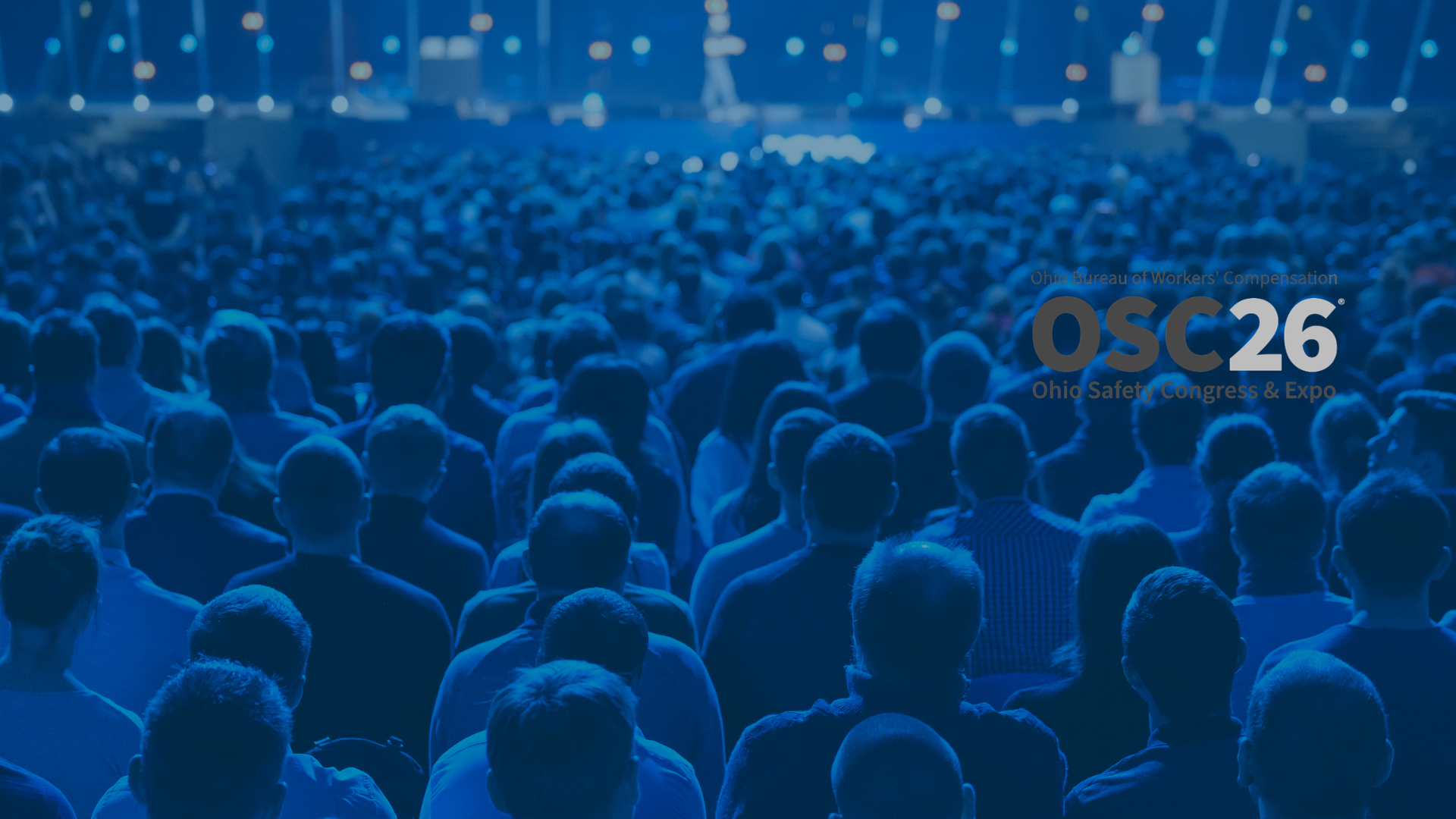OSC gray and white logo on conference audience image