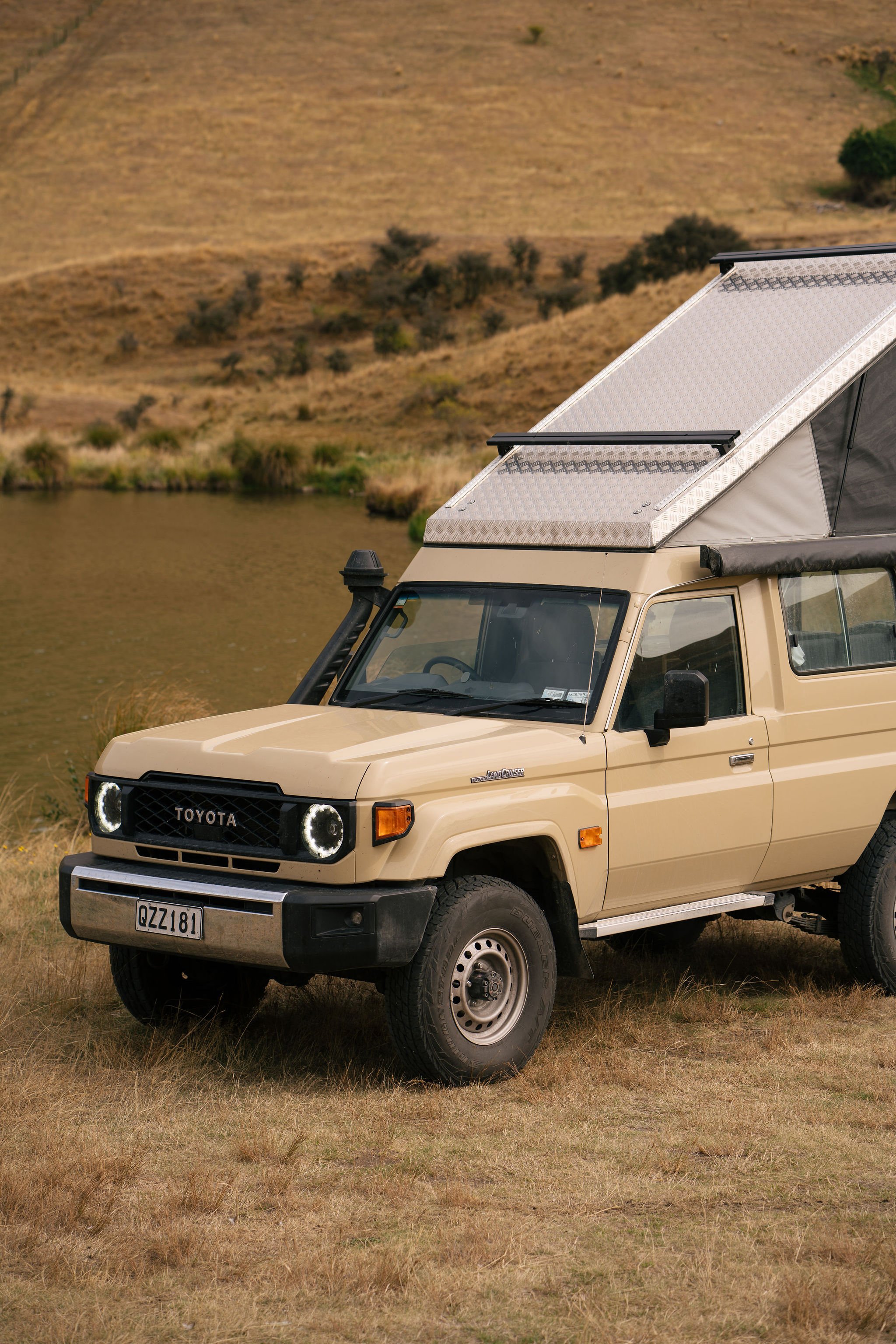 Toyota Land Cruiser Troopy with pop-top conversion parked by river – expedition build NZ