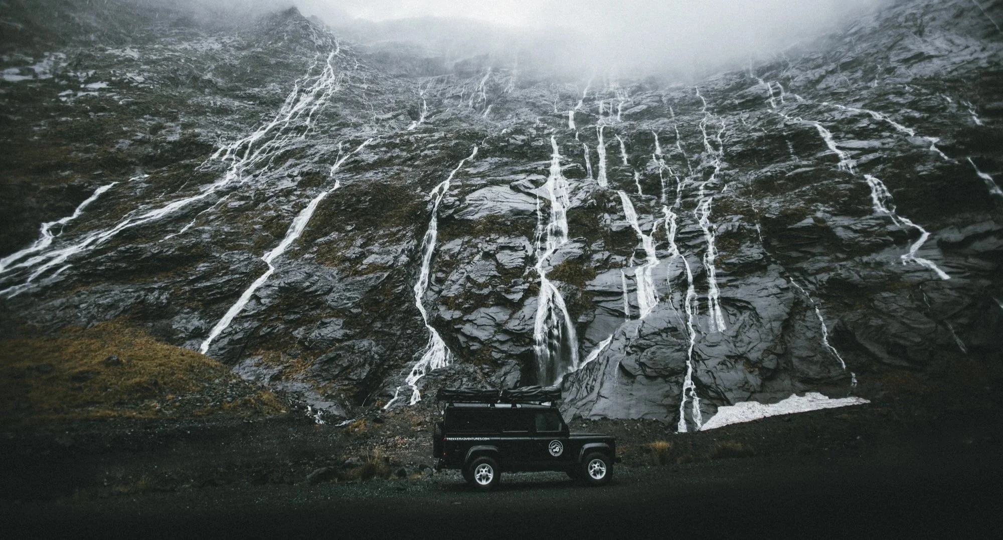 New Zealand alpine cliffs and waterfalls on South Island road trip