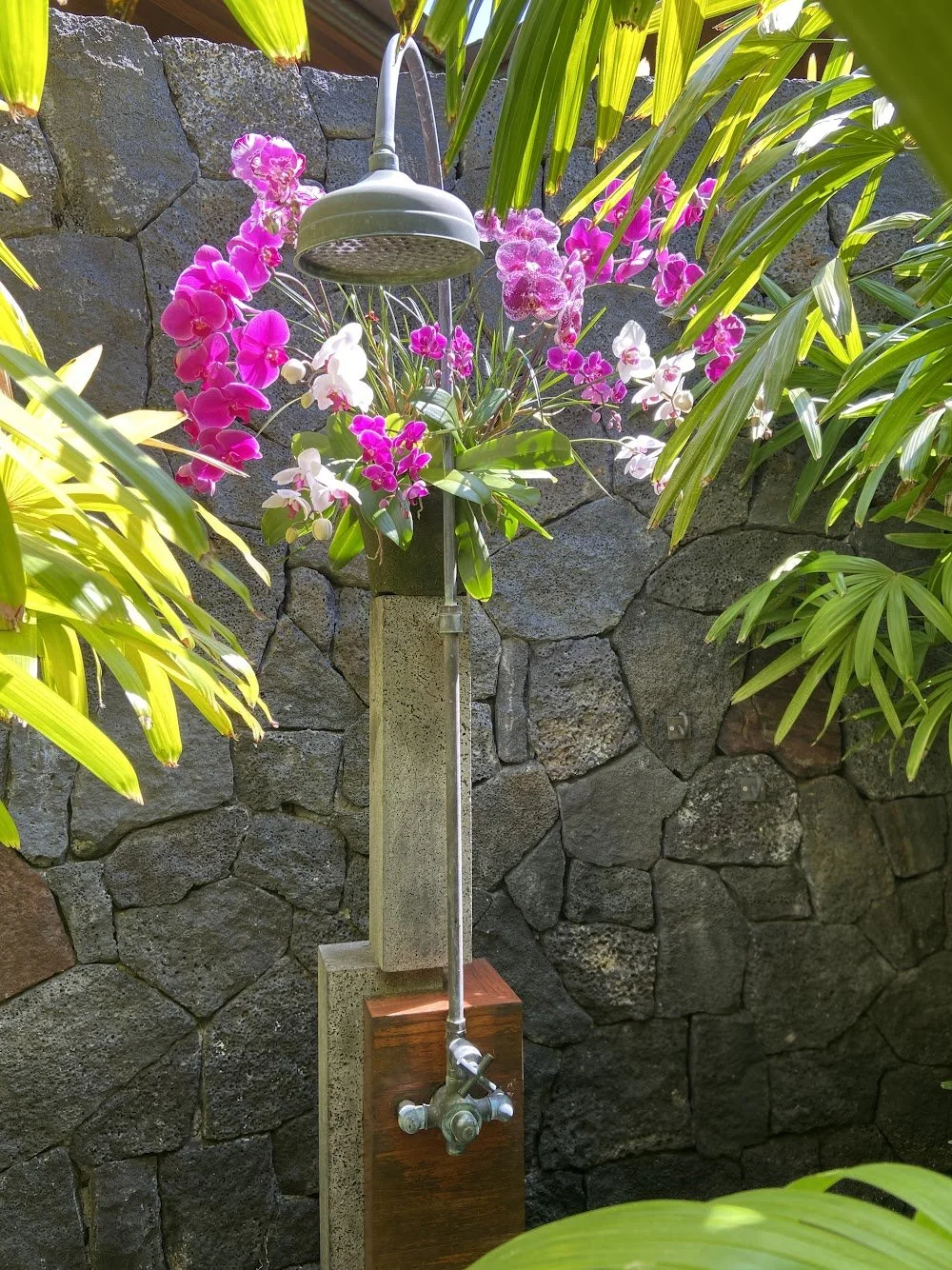 Custom orchid design installed in an outdoor shower by Anne Meheula.