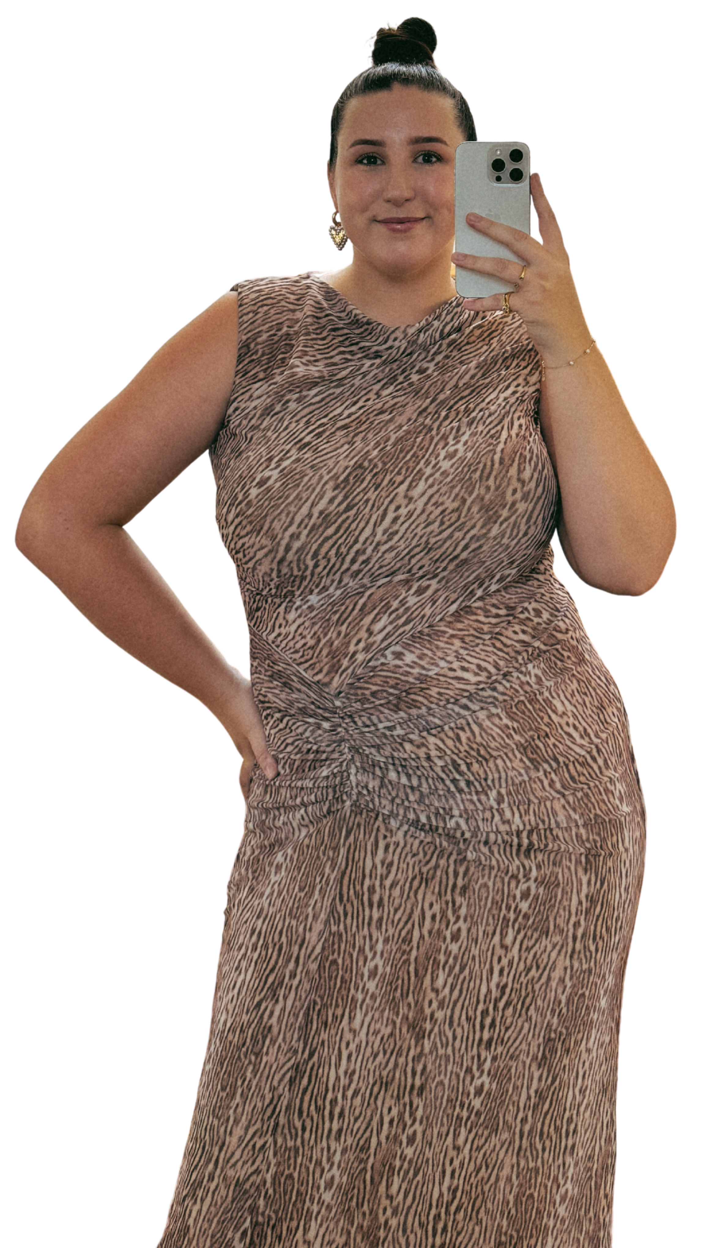 A woman in a sleeveless animal print dress taking a selfie with her smartphone.