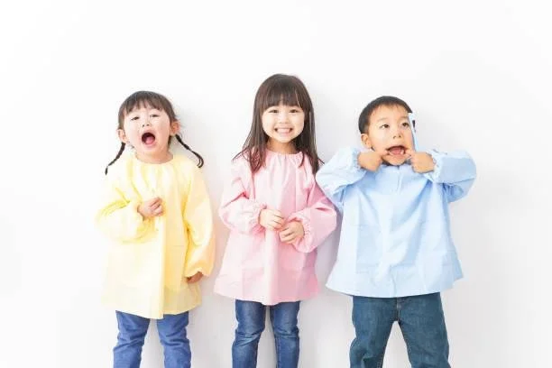 Three happy children smiling, booking a child's dental visit at Starlight Dental