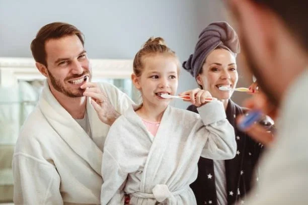 Family brushing their teeth together, booking a general dentistry visit at Starlight Dental
