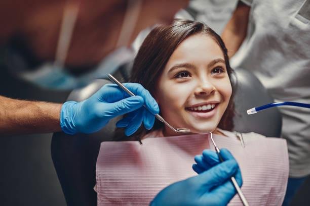 Smiling child at Starlight Dental during a dental sealant treatment — pediatric dentist applying protective sealants to prevent cavities and keep kids’ teeth strong and healthy.