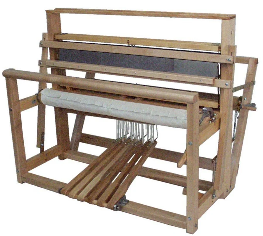 A large wooden weaving loom with various parts including a frame, warp rails, a woven cloth, and a shuttle where yarn is woven into fabric.