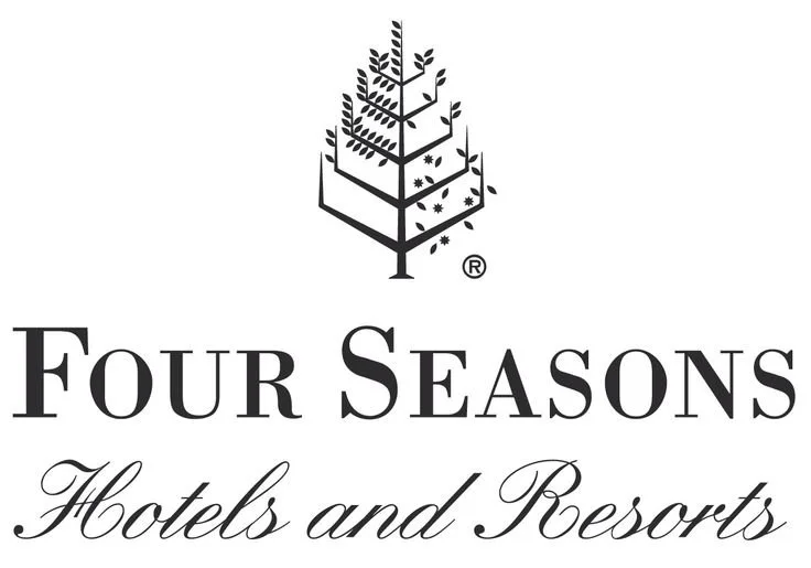 Logo for Four Seasons Hotels and Resorts featuring a stylized tree with leaves and branches.