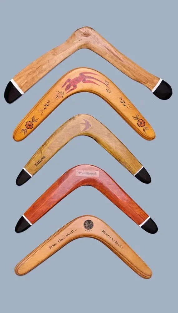A vertical display of five wooden hockey sticks, each with different designs and branding, against a light blue background.