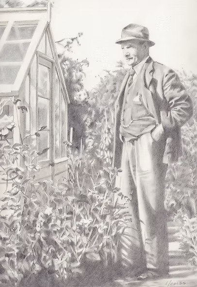 A man in a hat and suit standing outside a greenhouse, looking at plants.