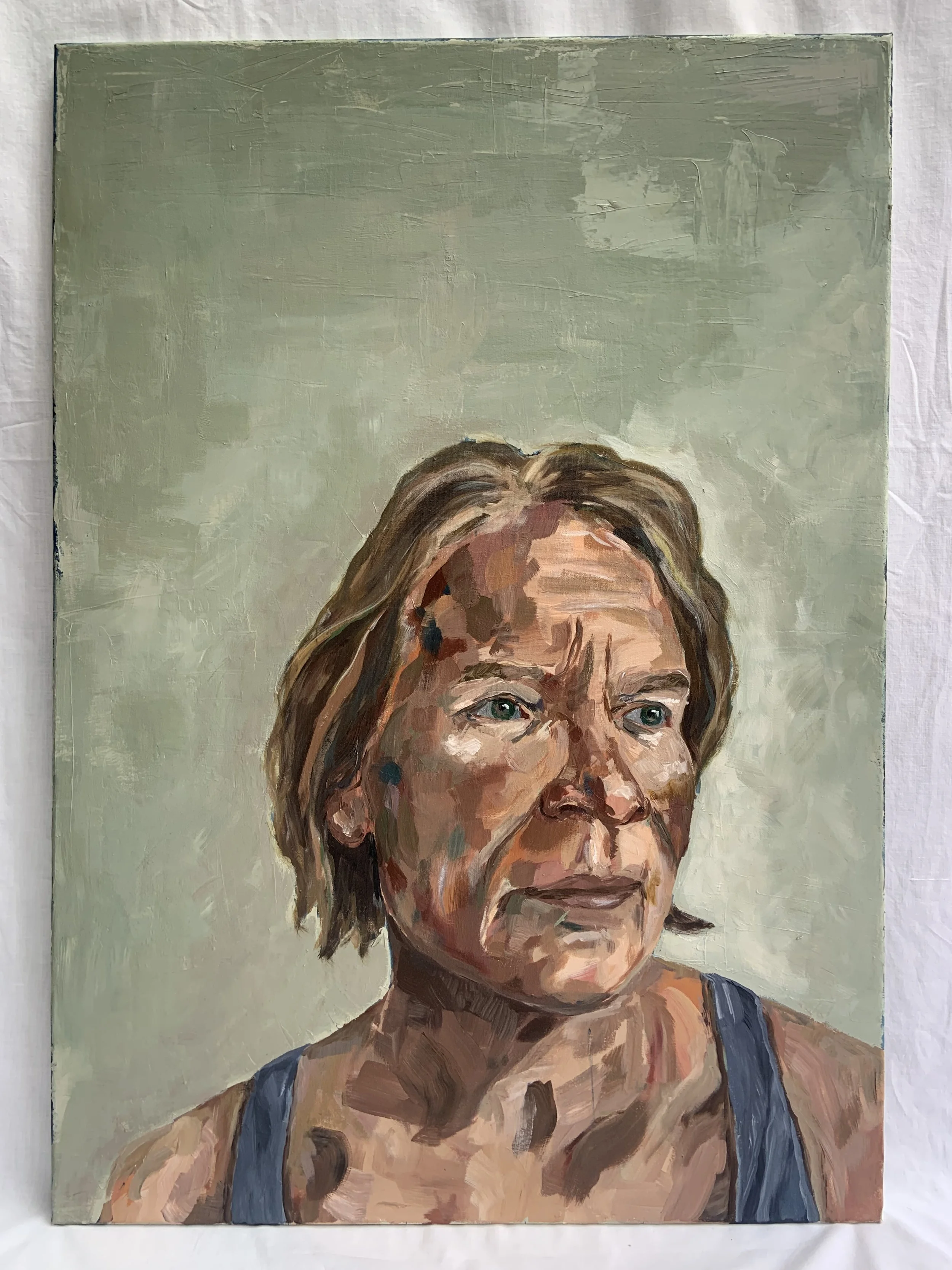 A painted portrait of an older woman with short brown hair, blue eyes, and a serious expression, wearing a dark tank top, against a light green background.