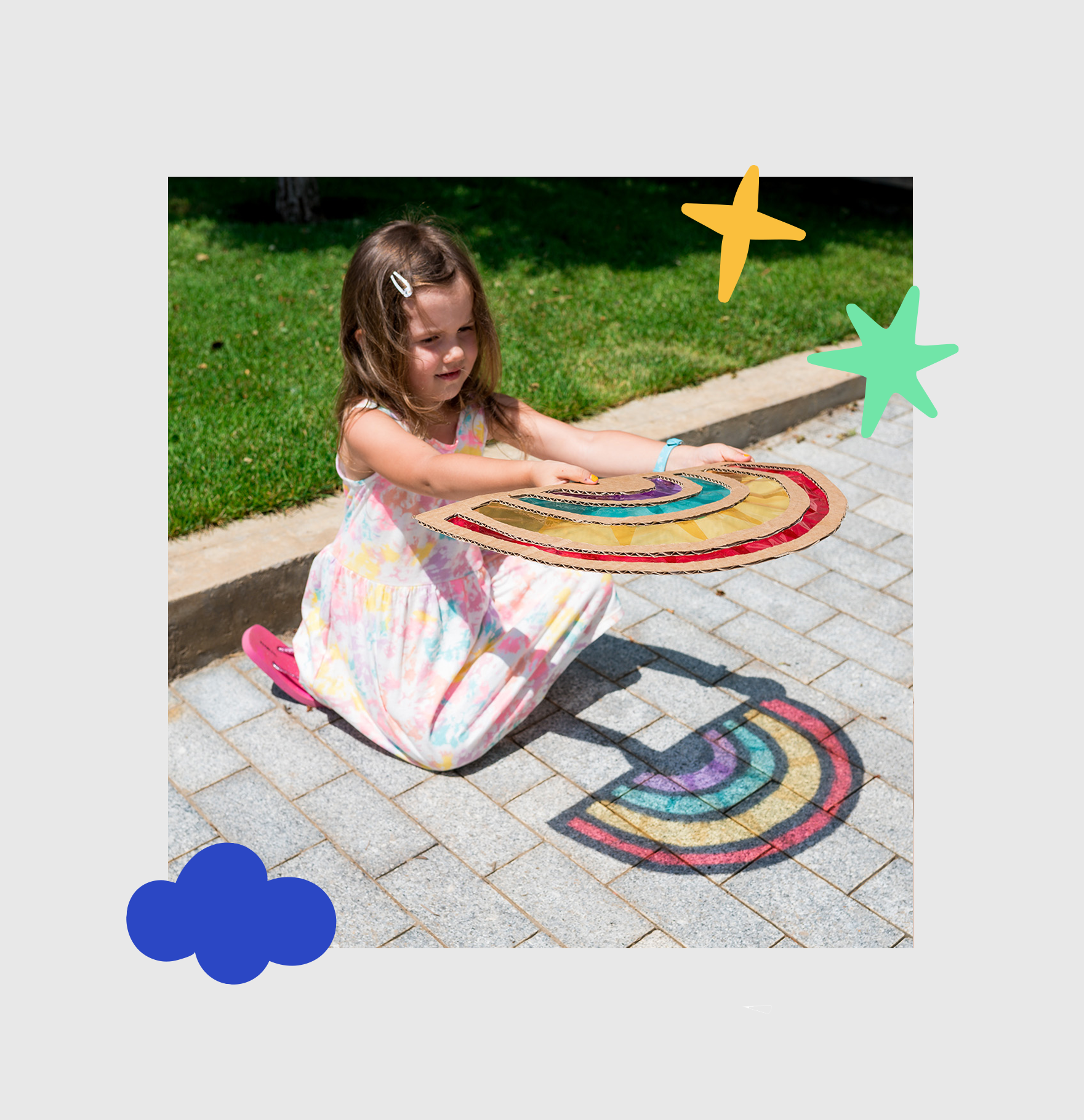 Young girl using a homemade suncatcher to see colours of light on the ground