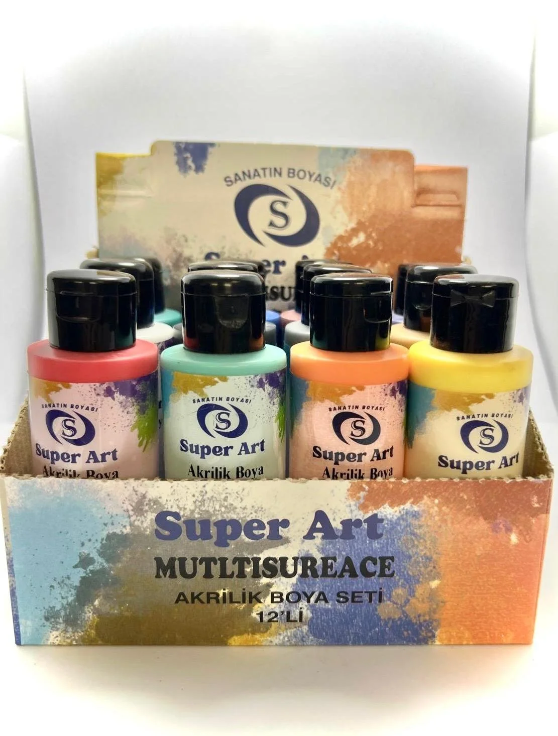 A display box of 12 bottles of Super Art acrylic paint in various colors with a colorful label and a partial background of a larger refilled container.