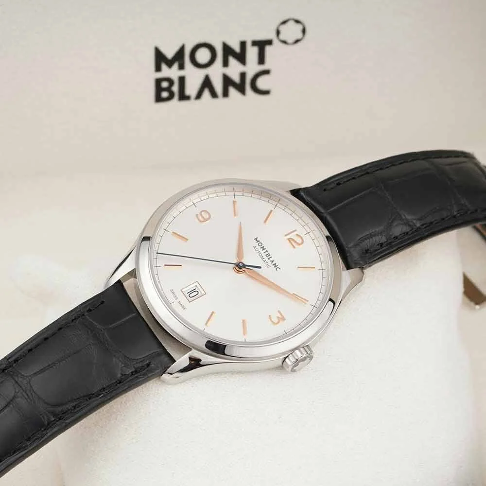 A Montblanc automatic wristwatch with a white dial, gold hour markers, and hands, a date window at the 6 o'clock position, with a black leather strap, placed against a white background with a Montblanc logo.