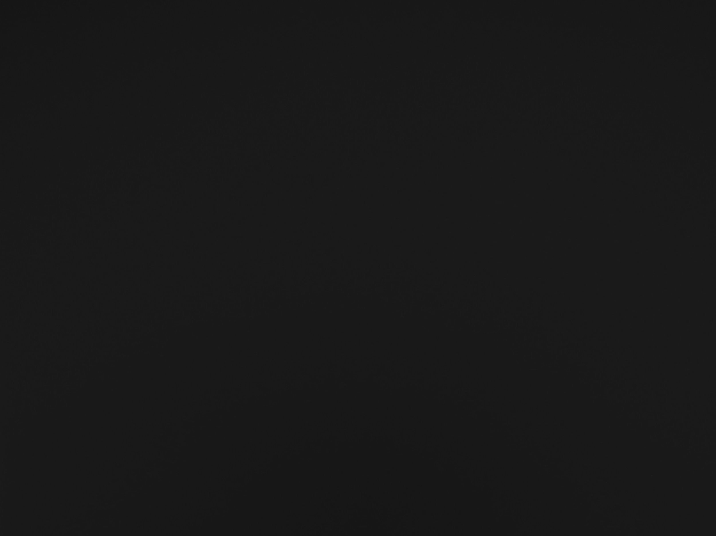 A dark image with faint outlines of mountain ranges under a starry night sky.