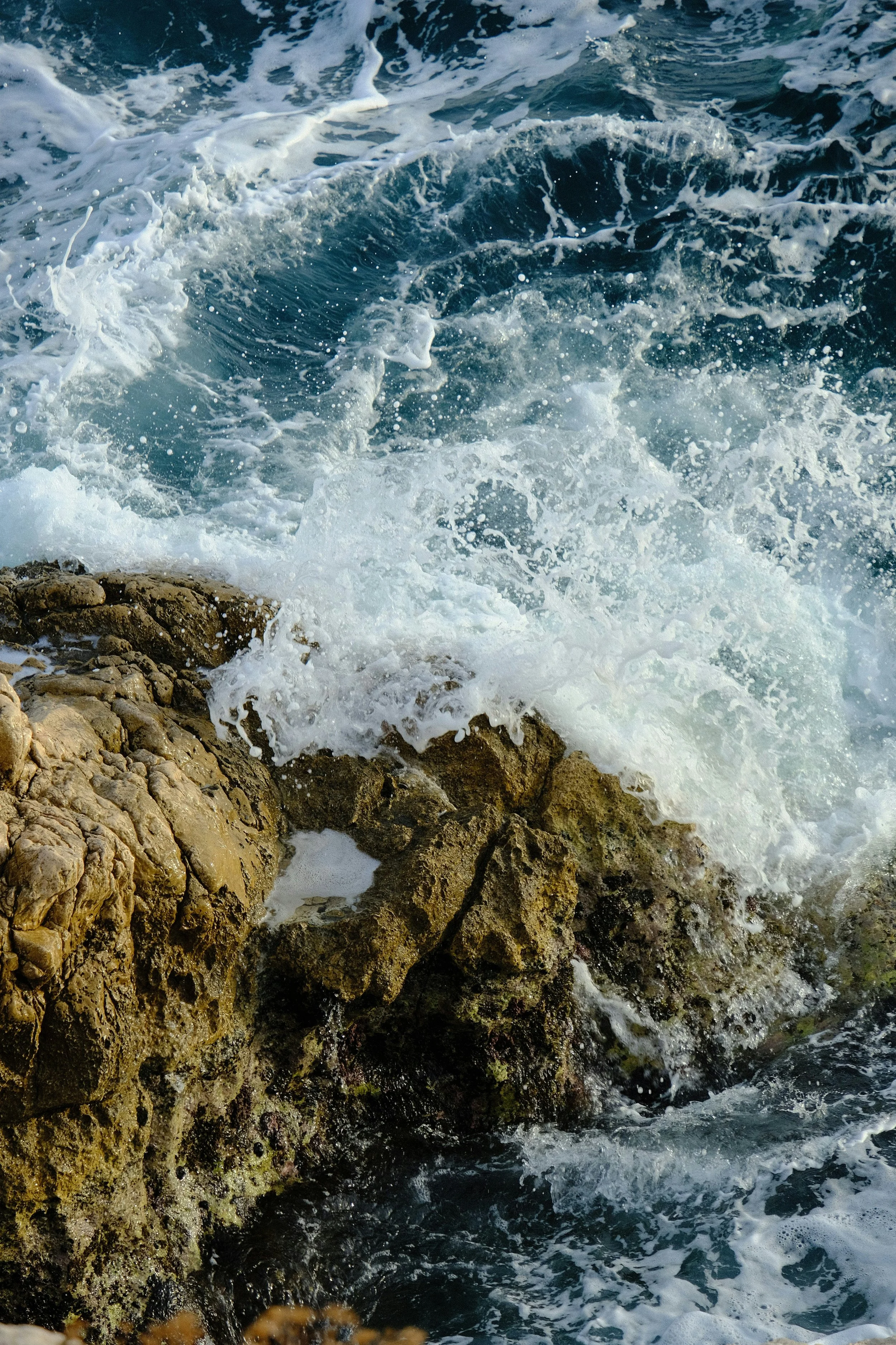 Waves crashing against rocks on the shoreline