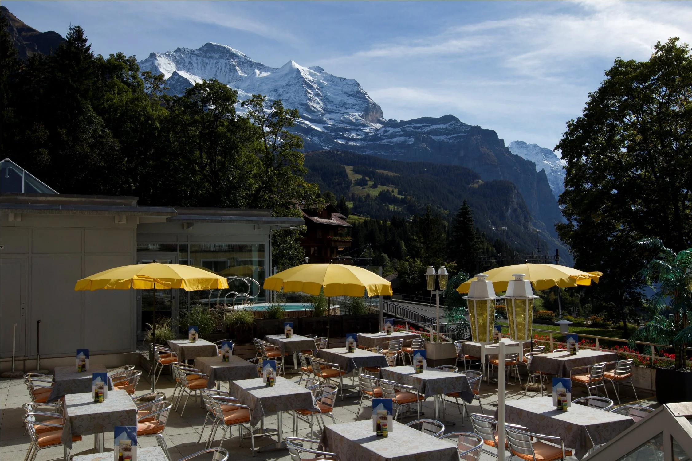 Sunny terrace at the hotel Silberhorn in Wengen overshadowed by the Eiger glacier.