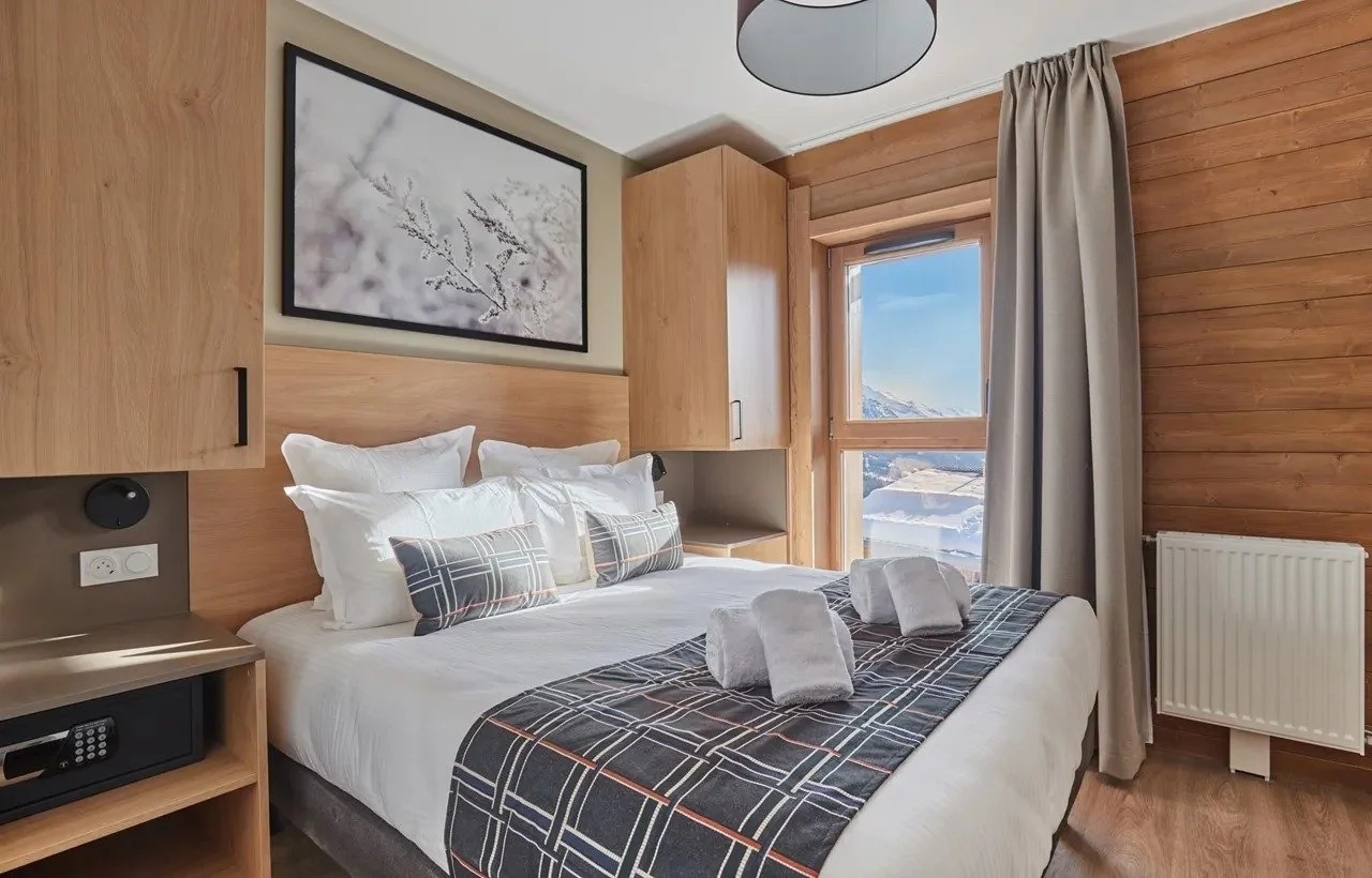 Double bedroom with mountain views and light alpine wood charm